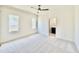 A bright room with two windows, soft carpet and a ceiling fan at 3315 Hampton Rd, Raleigh, NC 27607
