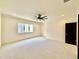 A spacious bedroom with neutral carpet, a ceiling fan, and a large window at 3315 Hampton Rd, Raleigh, NC 27607
