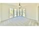 The bedroom has large windows, light gray carpet and a ceiling fan at 3315 Hampton Rd, Raleigh, NC 27607