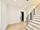 Bright foyer features wood-look flooring and modern stairs with metal railings at 3315 Hampton Rd, Raleigh, NC 27607