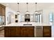 Open kitchen with large center island, quartz countertops, and modern pendant lighting above at 3315 Hampton Rd, Raleigh, NC 27607