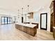 Open kitchen with large central island, quartz countertops, and modern pendant lights at 3315 Hampton Rd, Raleigh, NC 27607