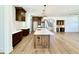 Open kitchen featuring a large island, modern appliances, and spacious design with wood flooring at 3315 Hampton Rd, Raleigh, NC 27607