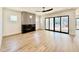Living room with a linear fireplace, large sliding doors, and wood flooring at 3315 Hampton Rd, Raleigh, NC 27607
