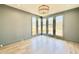 Bright room with hardwood floors, gray walls and a bay window with neighborhood view at 3315 Hampton Rd, Raleigh, NC 27607