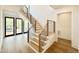 Modern staircase with wood treads, white risers, and a sleek black metal railing at 3315 Hampton Rd, Raleigh, NC 27607