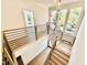 Modern staircase with wood and black metal railings and decorative pendant lights at 3315 Hampton Rd, Raleigh, NC 27607