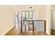 Modern staircase with wood and black metal railings and decorative pendant lights at 3315 Hampton Rd, Raleigh, NC 27607