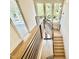 Modern staircase with wood and black metal railings and decorative pendant lights at 3315 Hampton Rd, Raleigh, NC 27607