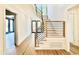 Open staircase with hardwood treads, white risers and contemporary black metal railing at 3315 Hampton Rd, Raleigh, NC 27607