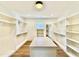 Bright walk-in closet with hardwood floors and a center island for storage at 3315 Hampton Rd, Raleigh, NC 27607
