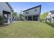 Expansive backyard with lush green grass, covered patio, and a detached garage at 3317 Hampton Rd, Raleigh, NC 27607