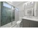 Modern bathroom featuring glass enclosed shower, tiled walls, and vanity with neutral walls at 3317 Hampton Rd, Raleigh, NC 27607