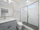 A modern bathroom with glass-enclosed shower, marble floors and vanity at 3317 Hampton Rd, Raleigh, NC 27607