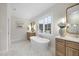 Bright bathroom featuring a large vanity, a soaking tub, and elegant finishes at 3317 Hampton Rd, Raleigh, NC 27607