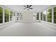 A large bedroom surrounded by large windows and neutral colored carpet at 3317 Hampton Rd, Raleigh, NC 27607