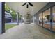Covered patio features stone floor, ceiling fans, outdoor kitchen, and seamless access to the indoors at 3317 Hampton Rd, Raleigh, NC 27607