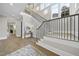 Stairway with hardwood floors, black railings, and white trim at 3317 Hampton Rd, Raleigh, NC 27607