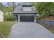 Detached garage with a dark gray exterior, paved driveway, and an upper level dormer at 3317 Hampton Rd, Raleigh, NC 27607