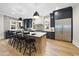 Spacious kitchen showcases an oversized island, stainless steel refrigerator, dark cabinets, and hardwood floors at 3317 Hampton Rd, Raleigh, NC 27607