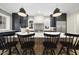 Modern kitchen boasts a large island, black cabinetry, stainless steel appliances, and stylish pendant lighting at 3317 Hampton Rd, Raleigh, NC 27607
