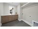 Modern laundry room includes gray tile floors, sink, countertops, and cabinet storage at 3317 Hampton Rd, Raleigh, NC 27607