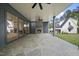 Spacious outdoor living area with stone flooring, fireplace, ceiling fans, and backyard view at 3317 Hampton Rd, Raleigh, NC 27607
