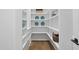 Well-organized walk-in pantry provides ample storage space with bright white shelving and wood floors at 3317 Hampton Rd, Raleigh, NC 27607