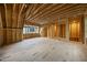 Unfinished room featuring a wood frame, plywood subfloor, and windows providing natural light at 3317 Hampton Rd, Raleigh, NC 27607