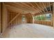 Unfinished room with exposed wood beams and many windows letting in natural light at 3317 Hampton Rd, Raleigh, NC 27607