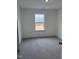 Bright bedroom with grey carpet and large window at 40 Shay St, Angier, NC 27501