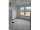 Bright bedroom with grey carpet and large windows at 40 Shay St, Angier, NC 27501