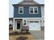 Two-story home with neutral siding, white garage door, and landscaping at 40 Shay St, Angier, NC 27501
