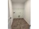 Laundry room with tile flooring and shelving at 40 Shay St, Angier, NC 27501