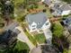 Aerial view of a luxurious home with a long driveway and a lush garden at 4005 Brevard Pl, Raleigh, NC 27609