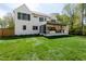 Expansive backyard featuring a covered patio, outdoor kitchen, and ample green space for outdoor activities and relaxation at 4005 Brevard Pl, Raleigh, NC 27609