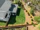 Aerial view of a beautifully landscaped backyard with lush green grass, manicured shrubs, and a wooden privacy fence at 4005 Brevard Pl, Raleigh, NC 27609