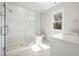 Modern bathroom featuring white tile, a glass-enclosed shower, and quartz countertop at 4005 Brevard Pl, Raleigh, NC 27609