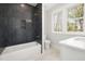 Modern bathroom with stylish dark tiling in the shower/tub, and a bright window at 4005 Brevard Pl, Raleigh, NC 27609