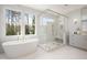 Elegant bathroom with soaking tub, glass shower, and marble finishes at 4005 Brevard Pl, Raleigh, NC 27609