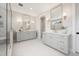 Bright primary bathroom with double vanity, marble floors and glass shower at 4005 Brevard Pl, Raleigh, NC 27609