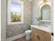 Charming half-bathroom with floral wallpaper, marble countertop, and wooden vanity at 4005 Brevard Pl, Raleigh, NC 27609