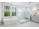 Spa-like bathroom with soaking tub, glass shower, and modern vanity at 4005 Brevard Pl, Raleigh, NC 27609