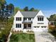 Stunning two-story home with a manicured lawn, attached garage, and classic white painted brick at 4005 Brevard Pl, Raleigh, NC 27609