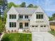 Striking white brick home with a manicured lawn and two-car garage at 4005 Brevard Pl, Raleigh, NC 27609