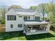 Rear exterior featuring an outdoor kitchen and living space in a well maintained backyard with green grass at 4005 Brevard Pl, Raleigh, NC 27609