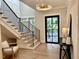 Bright foyer with stairs, modern light fixture, and view to the front door at 4005 Brevard Pl, Raleigh, NC 27609