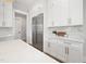 Kitchen features white cabinetry, stainless steel appliances, and marble countertops at 4005 Brevard Pl, Raleigh, NC 27609