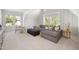 Bright living room with vaulted ceilings, neutral decor, comfortable seating, and multiple windows at 4005 Brevard Pl, Raleigh, NC 27609