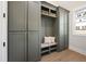Mudroom with gray built-in cabinets, bench, and coat hooks at 4005 Brevard Pl, Raleigh, NC 27609